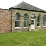 large arched white wooden windows with white wood door