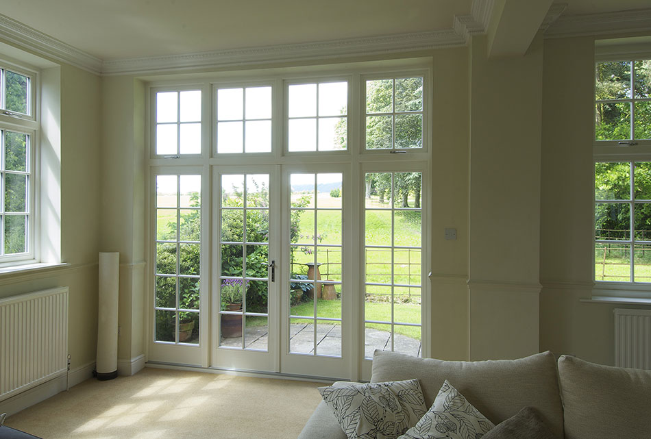 white wooden patio doors and windows with grids