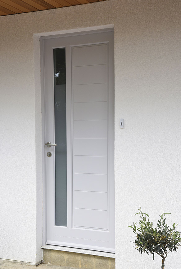 white wooden front door with silver handle