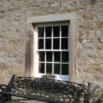 white large wooden sash window with panelling