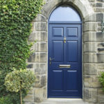 blue wooden front door with arched window