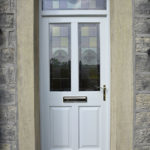 white wooden front door with stained glass windows