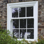 white wooden panelled front window