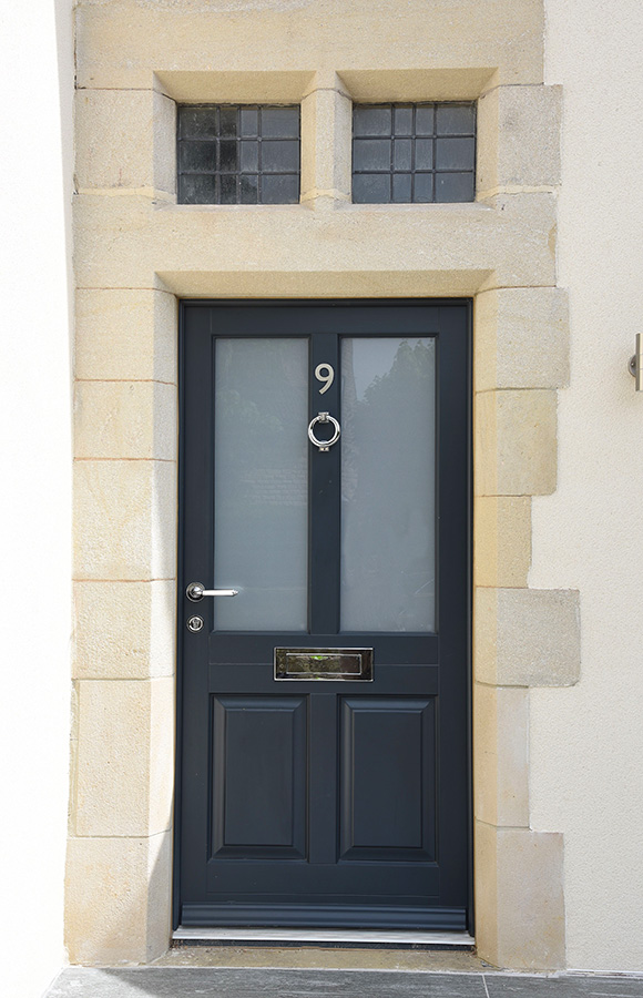 navy blue wooden front door with silver accents